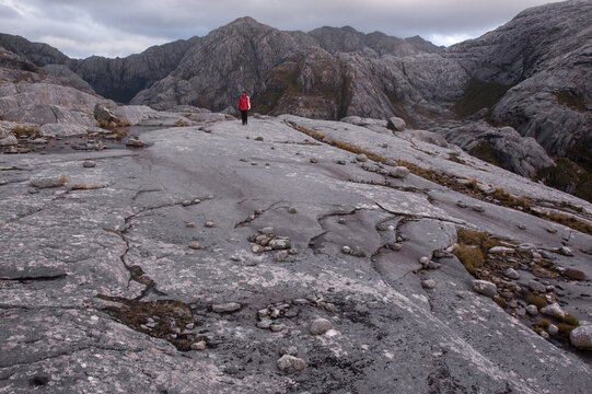 A person walking on big rocks