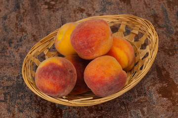 Peach heap in the wooden basket