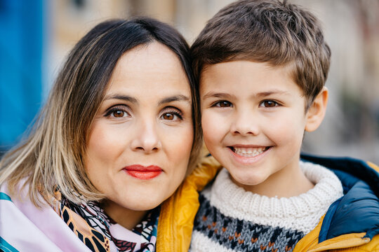 Portrait of young mother and son looking to camera