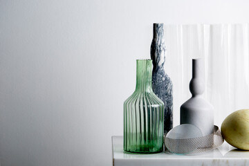 Clean and crisp still life of marble and glass ornaments on marble table top