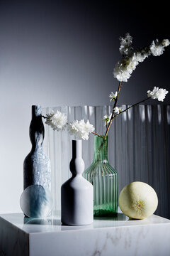 Still life of marble vases and Japanese cherry blossoms.