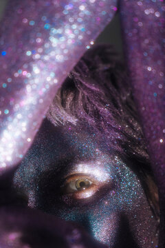 close-up eyes of a girl with cosmic shining bodypainting