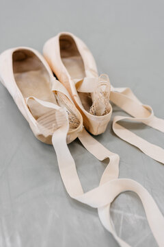 Top view of pointe shoes on dance studio floor