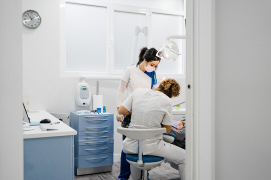 General view of Dentists with a patient from the door