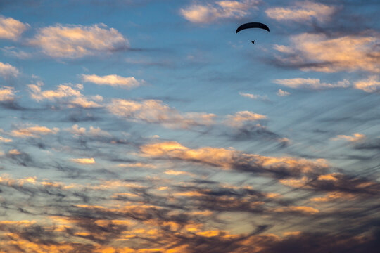 Paraglider in dramatic skies