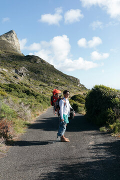 Young eco conscious farther hiking with son
