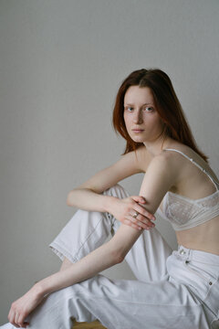 Portrait of a model in a white bra and trousers