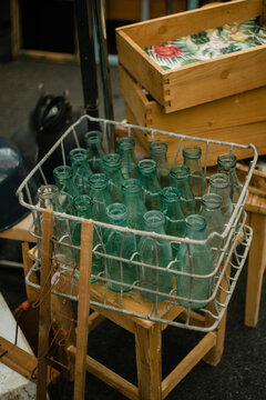 Vintage zero waste glass bottles in metal box on the street market