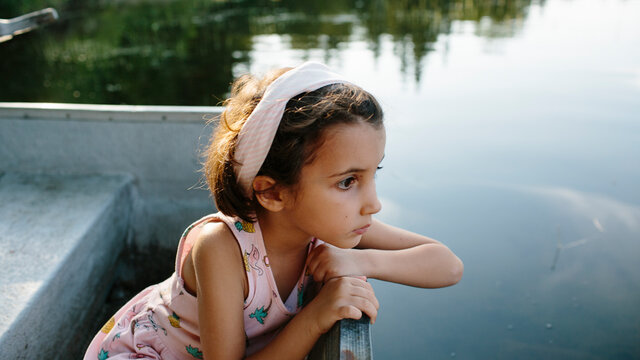 Kid on a boat in a lake