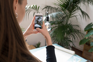 Businesswoman taking a picture of projects at office