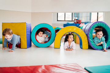 Happy multiethnic kids playing in kindergarten