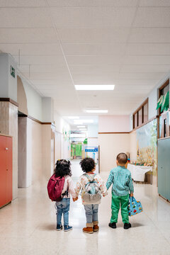 Happy kids walking in school corridor