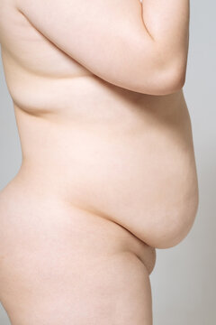 cropped image. Side view of a nude model plus size.