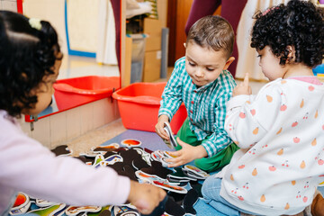 Multiracial toddlers playing on floor