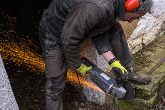 a man is using a metal saw