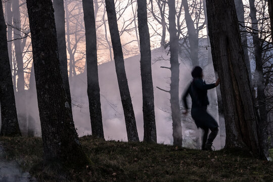 blurred woman looks at forest fire
