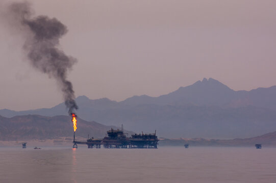 Off Shore Oil Rig In Red Sea With Mountains In The Background