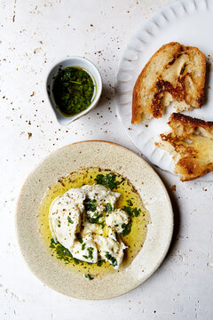Fresh burrata with herb oil and toasted sourdough bread