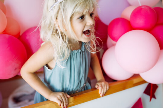 Happy little girl with bubbles and balloons