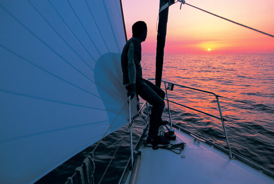 sailor absorbing the sunset at sea