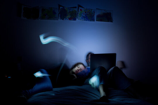 Couple lying in bed at night