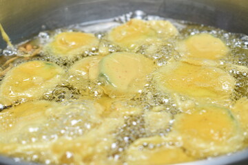 removing fried iNDIAN SUBCONTINENT FOOD PAKORA ,ALOO BHAJIYA