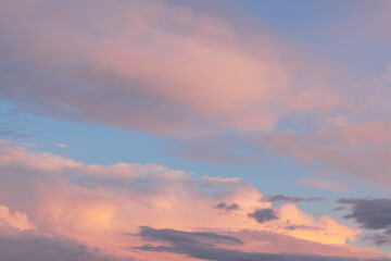 golden and pink clouds with soft haze on sunset as abstract background, texture.