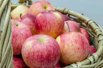 basket of willow twigs with ripe red apples