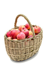 basket of willow twigs with ripe red apples