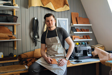 portrait of a mature man in his working leather workshop