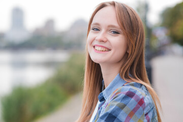 Portrait of a beautiful and happy girl outdoors