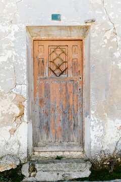 Old rusty door of abandoned house