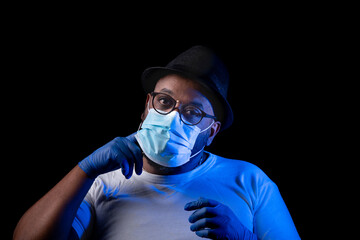 A black man scratching his face when he uses a face mask.