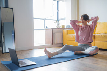 young woman getting ready for yoga lesson in video tutorial