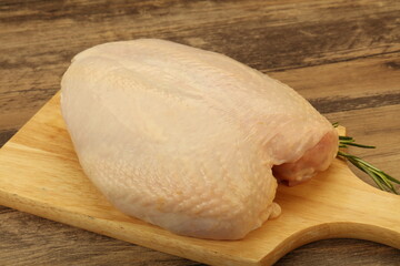 Raw whole chicken breast with skin