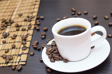 coffee in a white cup, and the coffee beans