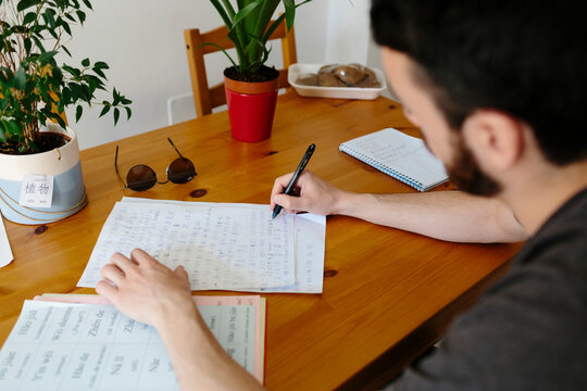 Back view of young Man writing