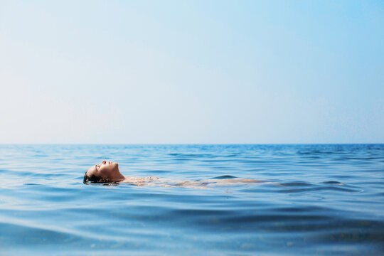 Woman lying on the water