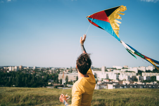 Man with flying colorful kite