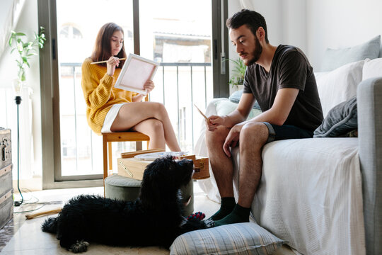 Man, woman and dog in their living room