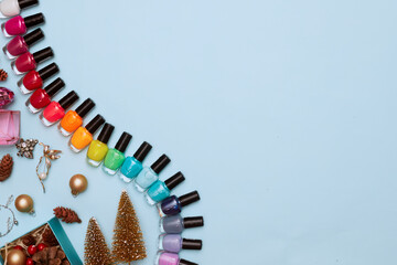christmas concept, new year, manicure with nail polish, pedicure on blue background, copy space,...