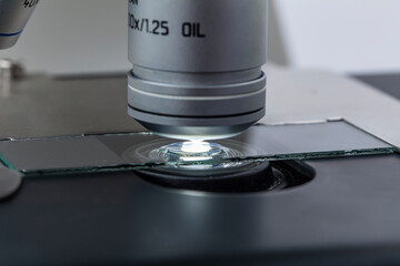 Distribution of immersion oil under light microscope objective lens. Oil immersion is a technique...
