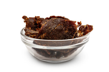 Glass bowl with beef jerky on white background.