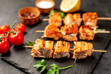 Delicious grilled salmon kebab on a stone background. Salmon kebab