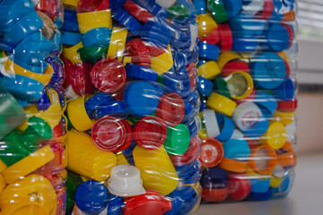 Obraz premium 5 liter plastic bottles full of colorful plastic caps; collecting plastic caps help people with special needs