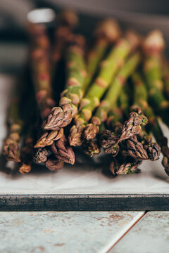 Raw Organic Asparagus Spears, on rustic surface