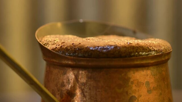 Turkish coffee simmering in ibrik and overflowing