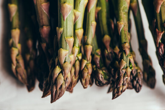 Raw Organic Asparagus Spears, on rustic surface