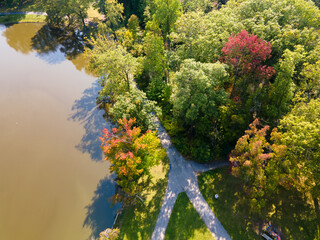 Aerial view of pond and trees just starting to change colors for fall.