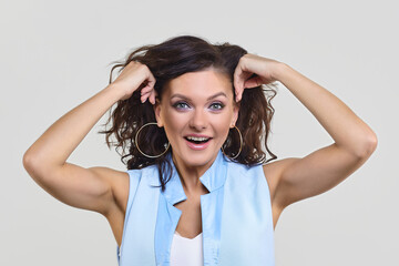 Fototapeta premium the attractive girl raised her hands to her head in surprise